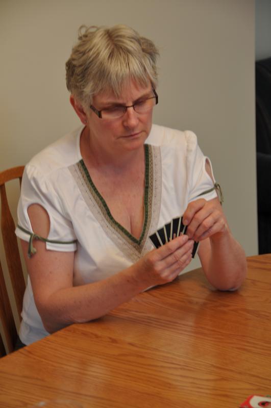 Kristina at the table playing cards..