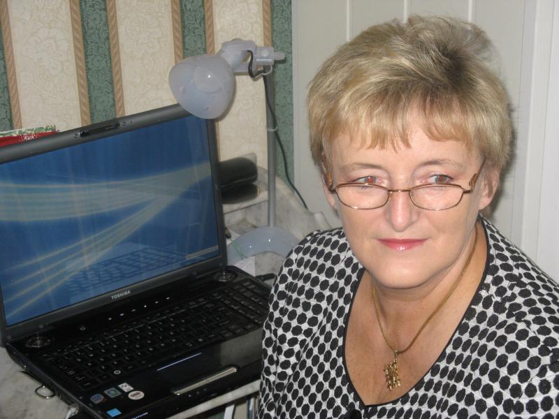 Urszula sitting by her new laptop.