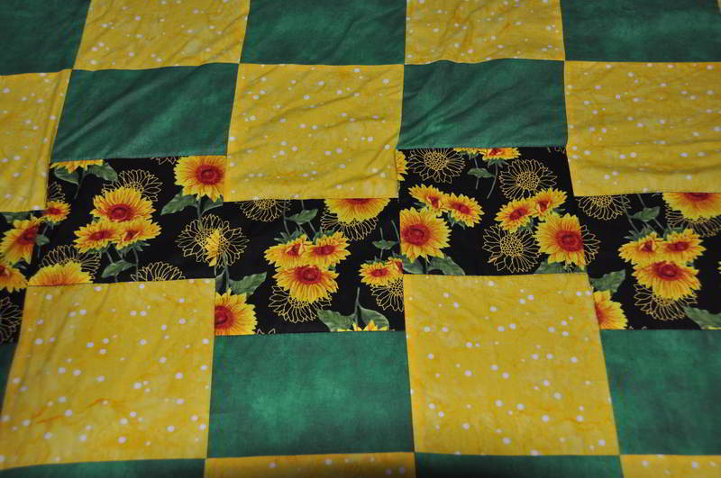 Close up the quilt's fabrics.