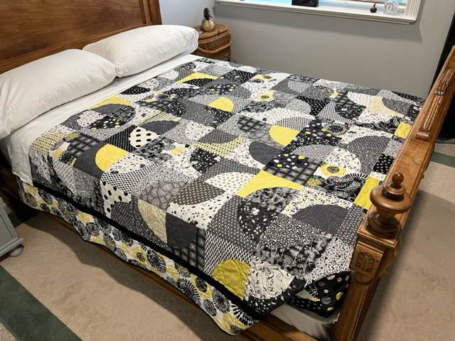 The quilt on a properly made up bed.