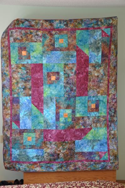 An art quilt in batik fabrics using a pattern from Modern Art with Fabric, by Debbie Maddy.