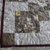 A Disappearing 9 Patch quilt pattern in brown paisley and rose fabrics, with a touch of burgundy.