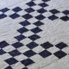 Double Irish Chain lap quilt in blue and white.