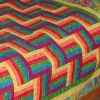 Fence rail pattern quilt in bright primary colours. Affectionately known as the harlequin quilt.