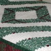 Green and white log cabin quilt, of barn raising pattern.
