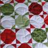 Summer Slices: a striking, brightly summer coloured quilt in reds, greens and white.